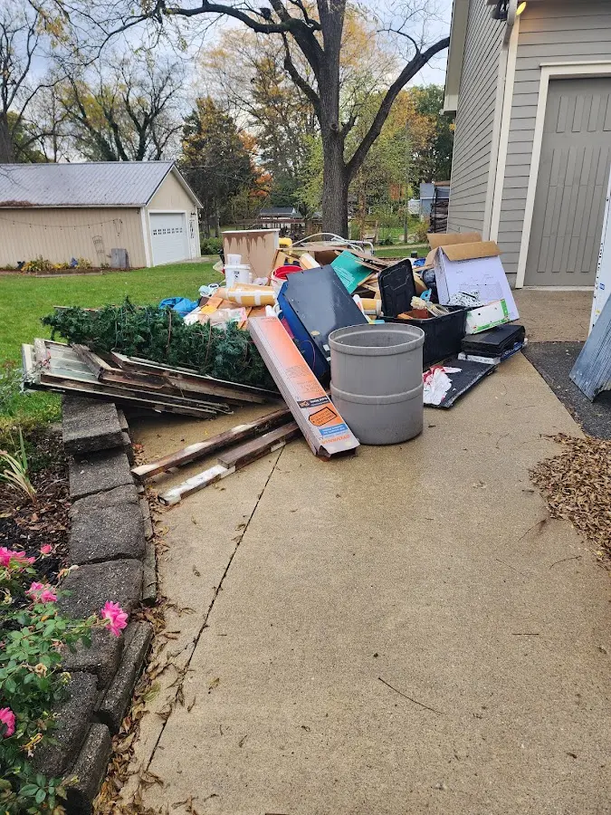 Dumpster being loaded with debris for Estate Cleanout Dumpster Rental in Hooper